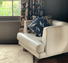 Load image into Gallery viewer, printed eucalyptus gumleaf on blue square linen designer cushion with tassels and handmade in Australia on designer leather lounge chair in dark brown room
