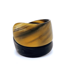 Load image into Gallery viewer, A gif animation of large dark coloured Old Fashioned Online Wide Minimalist polished black white and mushroom spiral Cuff bangle, made from ethically sourced natural horn