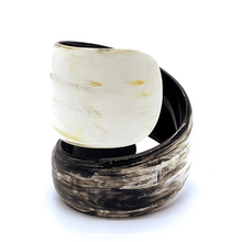Load image into Gallery viewer, A gif animation of large light coloured Old Fashioned Online Wide Minimalist polished black white and mushroom spiral Cuff bangle, made from ethically sourced natural horn