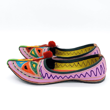 Load image into Gallery viewer, Ethically sourced bohemian Old Fashioned Online Pink Leather slip-on with blue, green and red triangle embroidery, red pompoms and cushioned footbed side view 1
