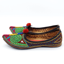 Load image into Gallery viewer, Ethically sourced bohemian Old Fashioned Online flats with purple, green and gold spiral path embroidery, red pompoms and cushioned footbed side view1