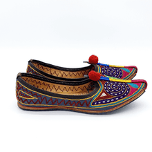 Load image into Gallery viewer, Ethically sourced bohemian Old Fashioned Online flats with purple, green and gold spiral path embroidery, red pompoms and cushioned footbed side view2