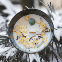 Load image into Gallery viewer, A picture of a large white candle sprinkled with Lemongrass, ginger root, rosella hibiscus flower & calendula flower and two crystals Green Aventurine and clear Quartz cimbedded in it