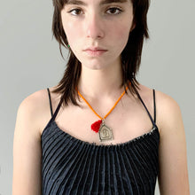 Load image into Gallery viewer, Orange Beaded Old Fashioned Online charm with red tassel and silver pendant charm on girl wearing pleated top
