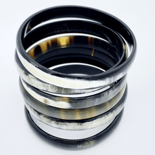 Load image into Gallery viewer, A picture of a stack of 6 slender monochrome Old Fashioned Online bangle bracelet, ethically sourced natural buffalo horn