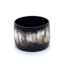 Load image into Gallery viewer, A picture spinning of Polished Black with accents of white and mushroom Old Fashioned Online Gypsy cuff bangle bracelet, ethically sourced natural buffalo horn