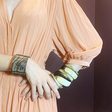 Load image into Gallery viewer, girl in peach dress wearing natural buffalo horn bracelet and several polished Horn bangles